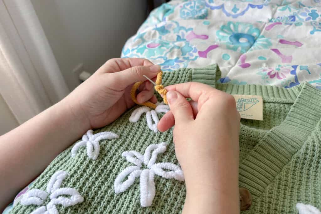 Three twists of yarn on the needle, tension being held gently. 