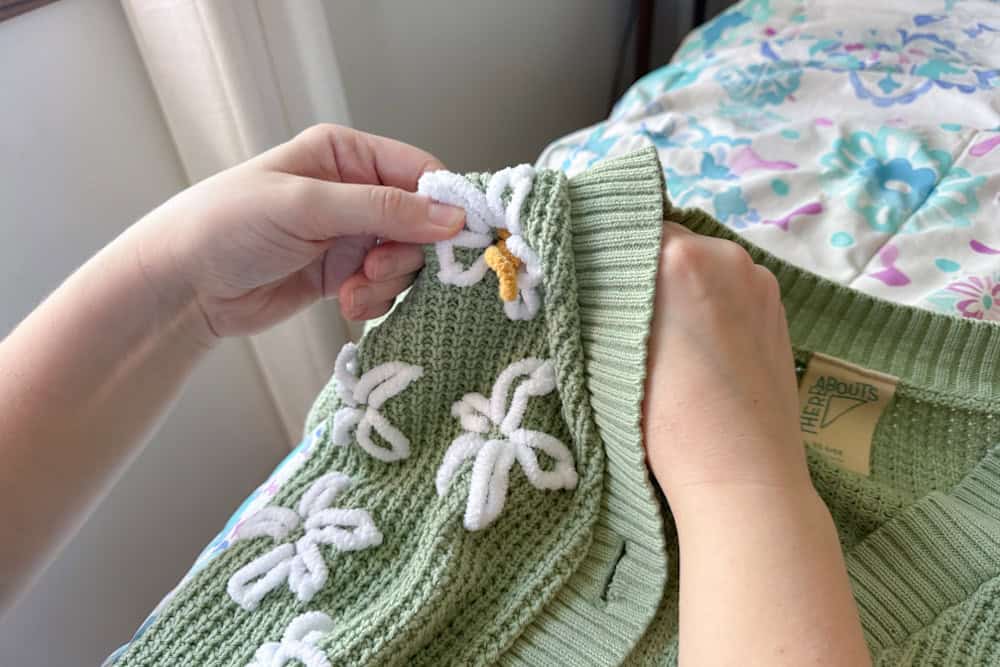 Needle pulled back through slowly creating a yellow center for the flower.