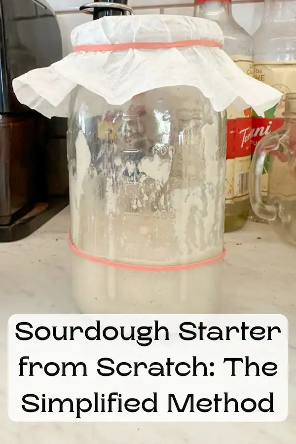Picture of sourdough starter in a quart jar covered with a coffee filter that's secured with a rubber band.