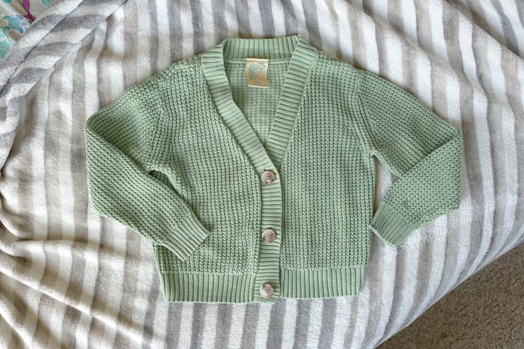 Plain sage green sweater before it was embroidered.